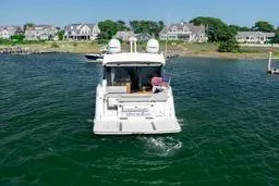 Slide: The Image of 2017 Sea Ray Sundancer 460 yacht cruising near coastal homes. - 4