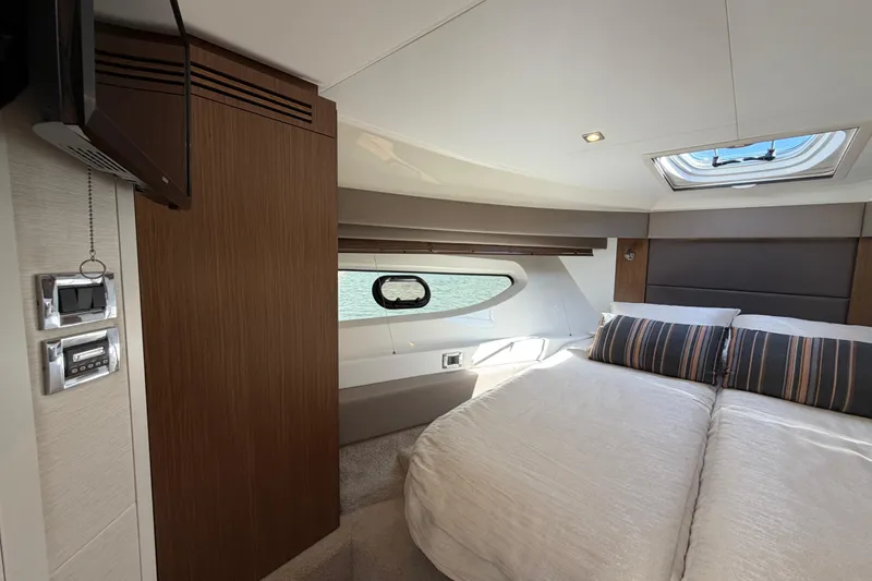 Slide: The Image of Luxurious 2017 Sea Ray Sundancer 460 yacht cabin with elegant bedding and modern amenities. - 35