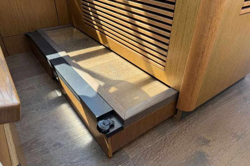Slide: The Image of Wooden interior detail of 2017 Sea Ray Sundancer 460 yacht, featuring a step and vented panel. - 25