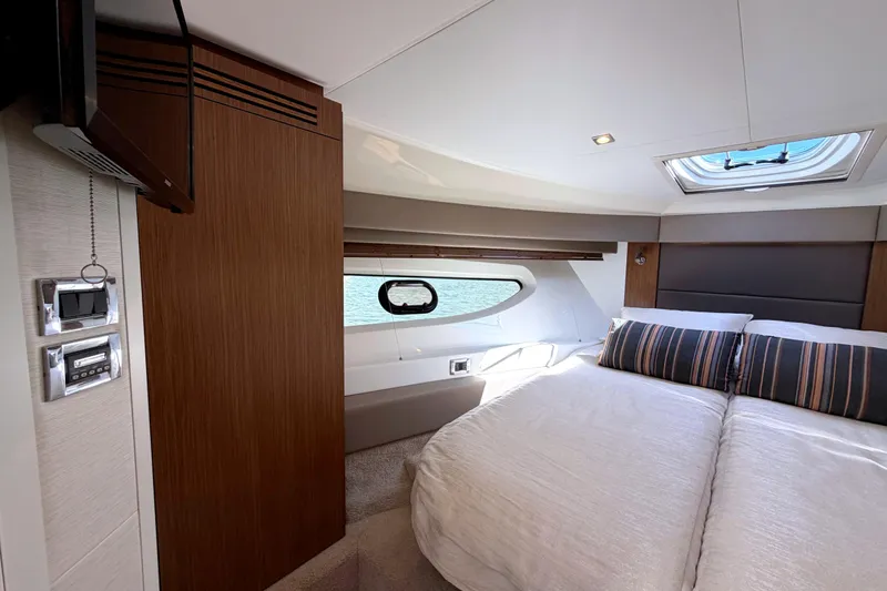 Slide: The Image of Luxurious 2017 Sea Ray Sundancer 460 yacht cabin with elegant bedding and modern amenities. - 51