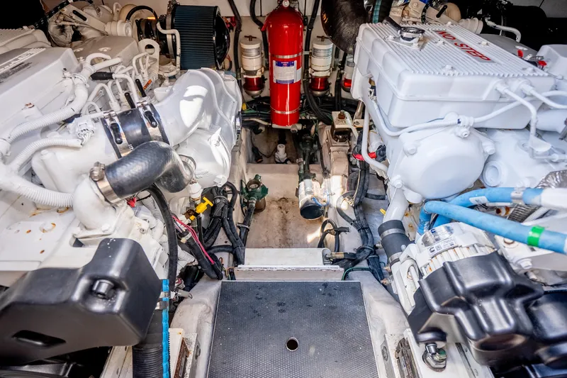 Slide: The Image of Engine room of 2017 Sea Ray Sundancer 460, showcasing mechanical components and fire extinguisher. - 67