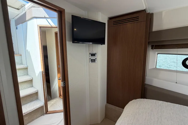Slide: The Image of Interior of 2017 Sea Ray Sundancer 460 yacht with TV and stairs to deck. - 30
