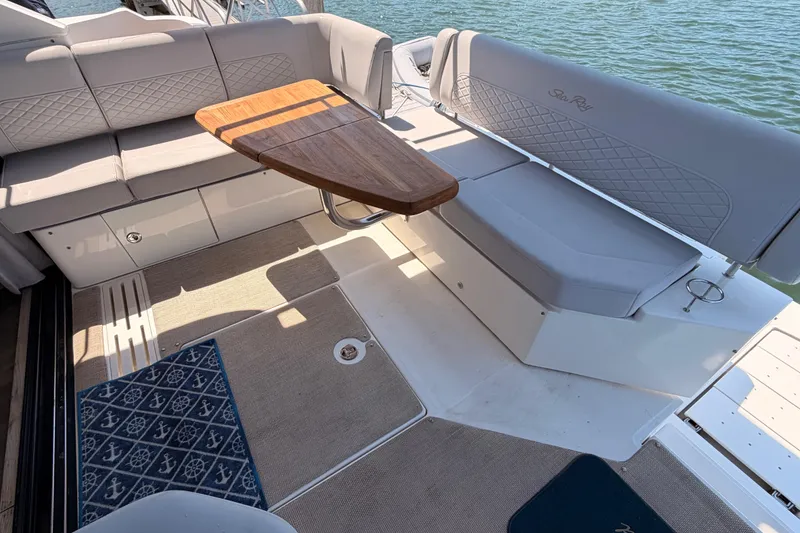 Slide: The Image of 2017 Sea Ray Sundancer 460 yacht interior with elegant seating and wooden table. - 14