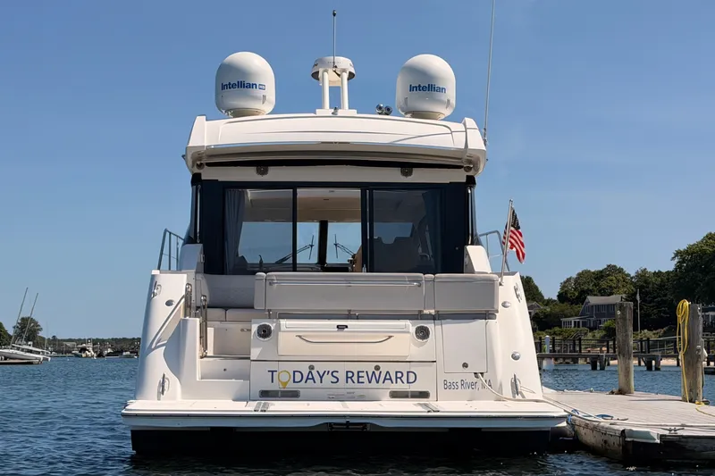 Slide: The Image of 2017 Sea Ray Sundancer 460 yacht docked, rear view with "Today's Reward" name visible. - 4