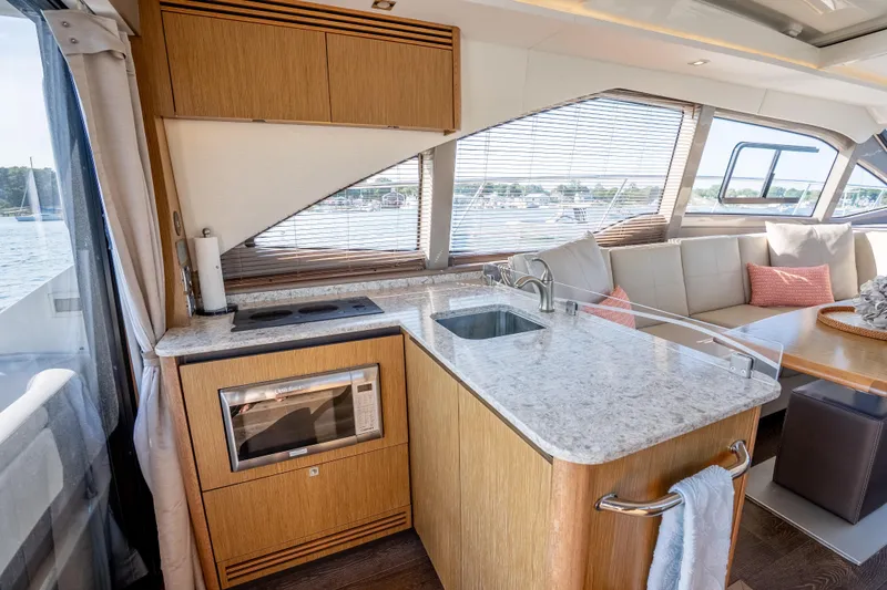 Slide: The Image of Luxurious interior of 2017 Sea Ray Sundancer 460 yacht with modern kitchen and seating area. - 32