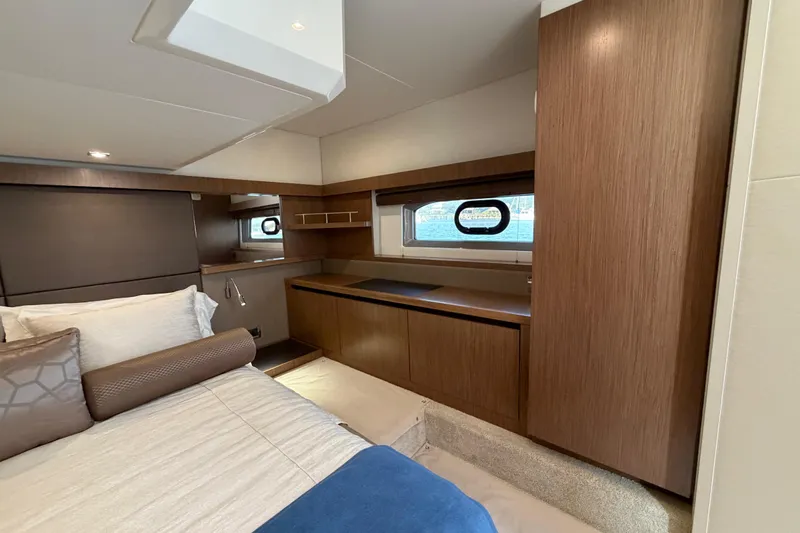 Slide: The Image of Luxurious 2017 Sea Ray Sundancer 460 cabin interior with elegant wood finishes and cozy bedding. - 40