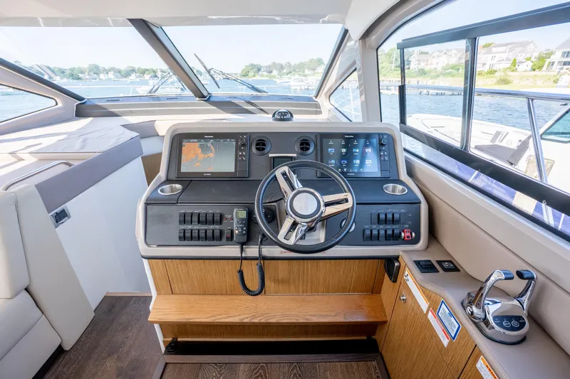 Slide: The Image of 2017 Sea Ray Sundancer 460 helm with modern navigation controls and panoramic windows. - 40