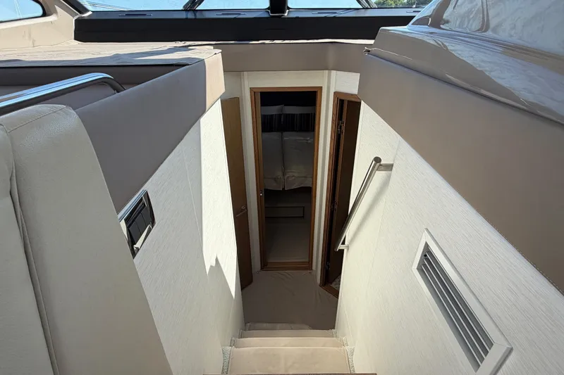 Slide: The Image of Interior view of 2017 Sea Ray Sundancer 460 yacht, featuring stairs leading to cabin. - 28