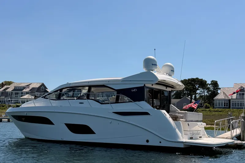 Slide: The Image of 2017 Sea Ray Sundancer 460 yacht docked near waterfront homes. - 2