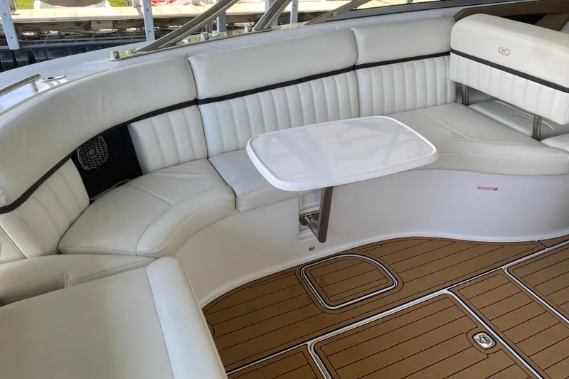 Slide: The Image of Luxurious 2015 Cobalt 336 boat interior with white leather seating and wooden flooring. - 23