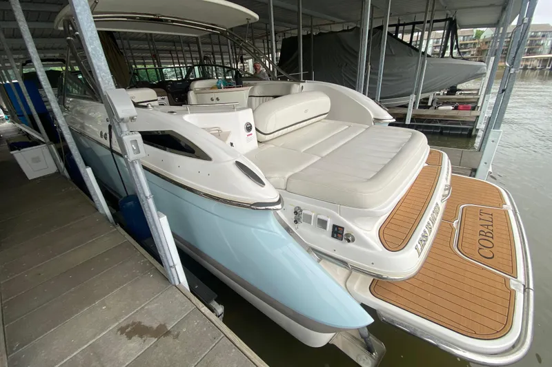 Slide: The Image of 2015 Cobalt 336 boat docked, featuring spacious seating and elegant design. - 11