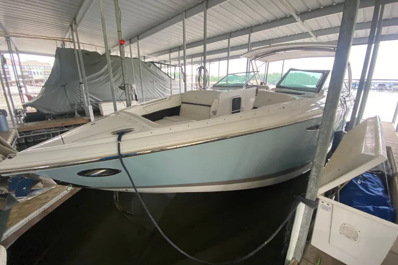 Slide: The Image of 2015 Cobalt 336 boat docked in covered marina, side view. - 10