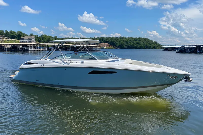 Slide: The Image of 2015 Cobalt 336 boat cruising on a sunny lake with clear skies. - 1