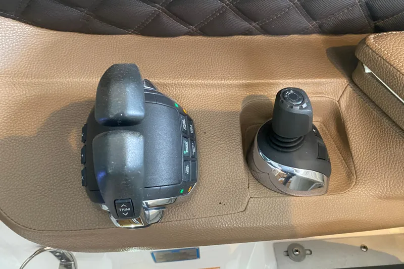Slide: The Image of Control panel of a 2015 Cobalt 336 boat with joystick and throttle levers. - 33
