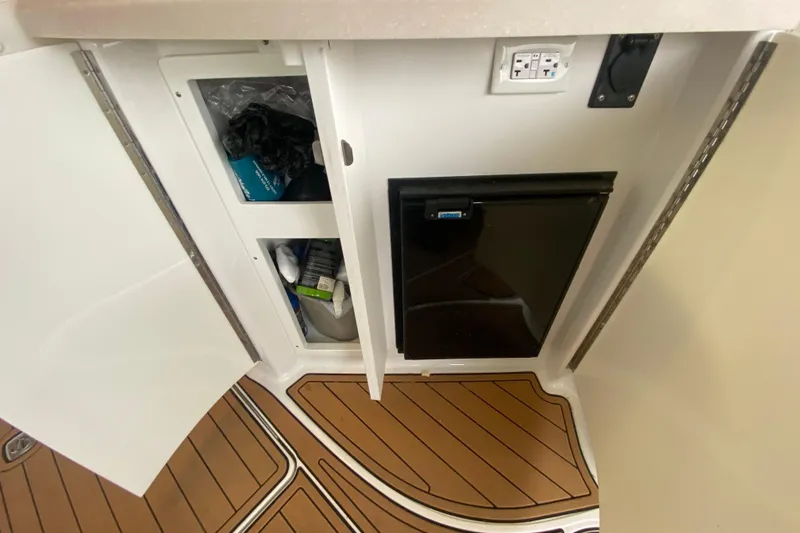 Slide: The Image of 2015 Cobalt 336 boat interior with storage cabinet and mini fridge. - 19