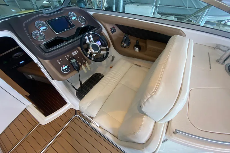 Slide: The Image of 2015 Cobalt 336 boat cockpit with steering wheel and control panel. - 26