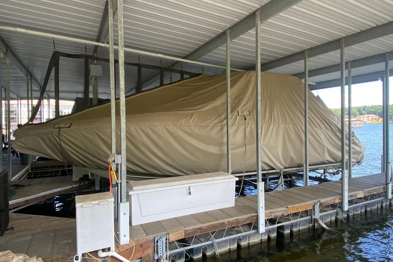 Slide: The Image of Covered 2015 Cobalt 336 boat docked in a sheltered marina. - 53
