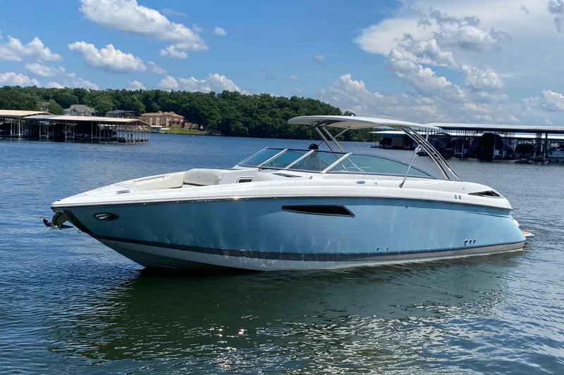 Slide: The Image of 2015 Cobalt 336 boat on a serene lake under a blue sky. - 2