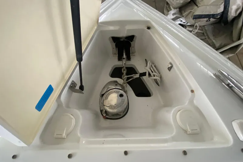 Slide: The Image of Anchor compartment of a 2015 Cobalt 336 boat, featuring chain and rope storage. - 39