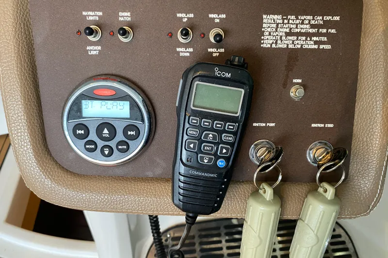 Slide: The Image of Control panel of a 2015 Cobalt 336 boat with radio and ignition keys. - 32