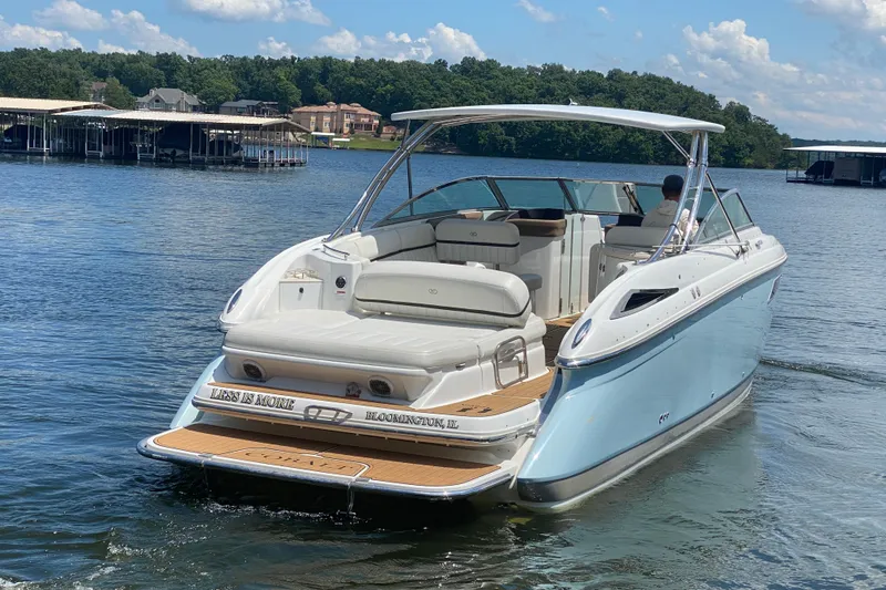 Slide: The Image of 2015 Cobalt 336 boat cruising on a lake with scenic background. - 8