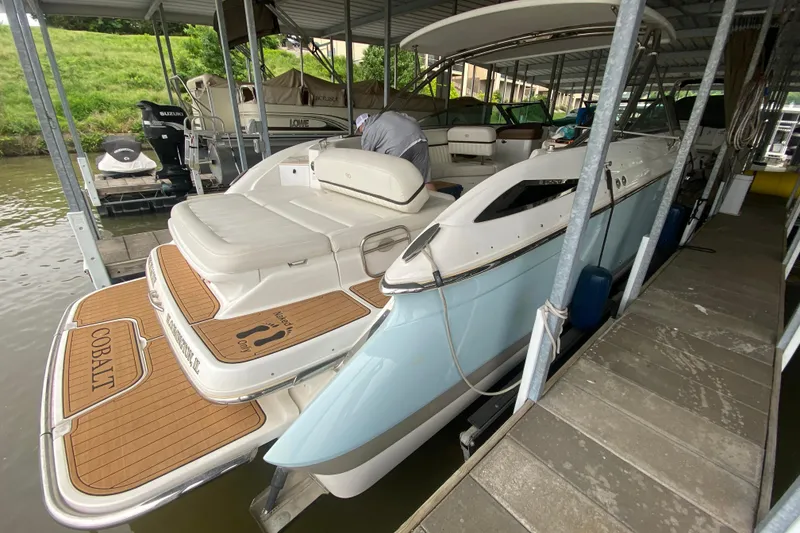 Slide: The Image of 2015 Cobalt 336 boat docked, featuring spacious seating and elegant design. - 13