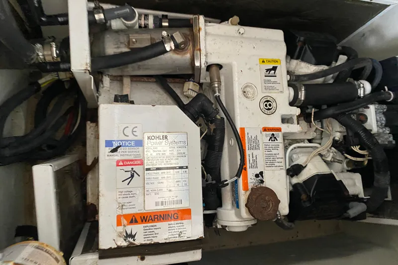 Slide: The Image of Engine compartment of a 2015 Cobalt 336 with Kohler power system and warning labels. - 51