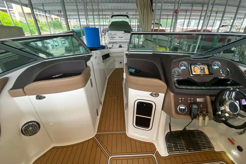 Slide: The Image of 2015 Cobalt 336 boat interior with modern dashboard and wood-style flooring. - 35