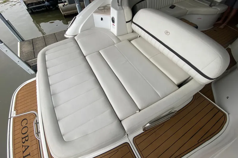 Slide: The Image of Luxury seating on a 2015 Cobalt 336 boat with elegant white upholstery. - 16