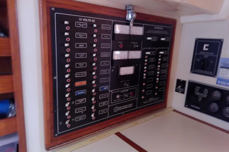 Slide: The Image of Electrical control panel on a 1988 Brewer 44 boat, featuring switches and meters. - 61