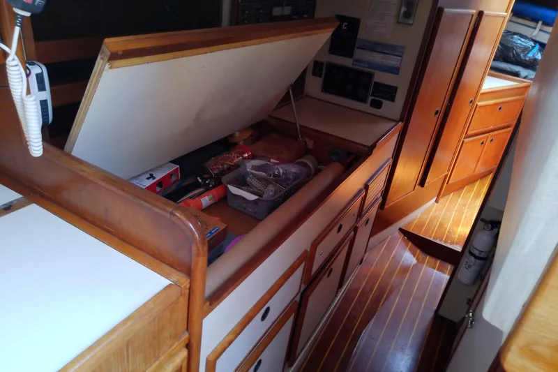Slide: The Image of Interior of a 1988 Brewer 44 sailboat with open storage and wooden cabinetry. - 59