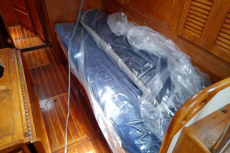 Slide: The Image of Wooden interior of 1988 Brewer 44 boat with plastic-covered cushions. - 43