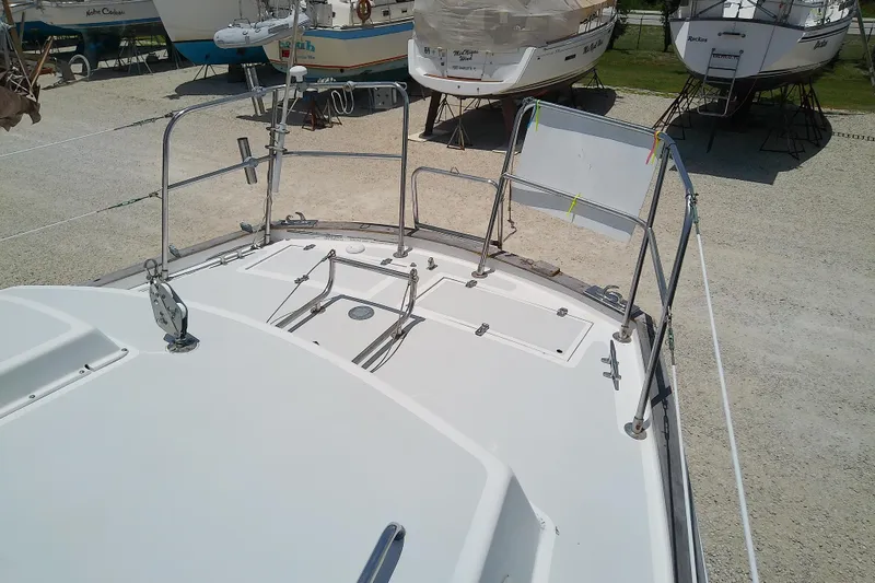 Slide: The Image of 1988 Brewer 44 sailboat deck view in a boatyard setting. - 23