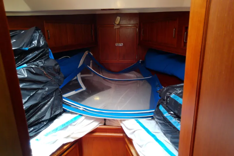 Slide: The Image of Interior of a 1988 Brewer 44 sailboat cabin with stored sails and equipment. - 66