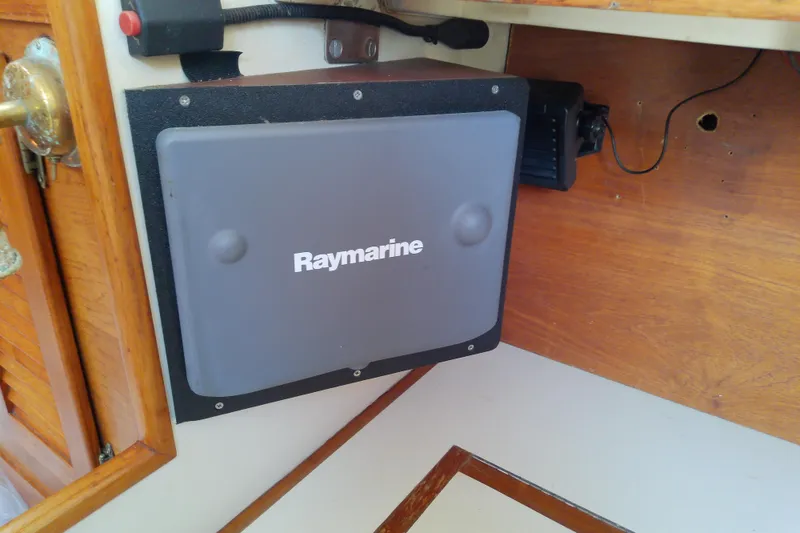Slide: The Image of Raymarine navigation equipment inside a 1988 Brewer 44 sailboat cabin. - 56