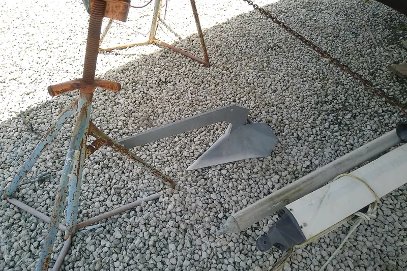 Slide: The Image of Rusty boat stand and anchor on gravel, Brewer 44 model, 1988. - 3