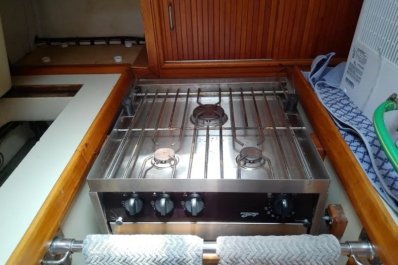 Slide: The Image of Stainless steel stove in a 1988 Brewer 44 yacht kitchen, featuring wooden cabinetry. - 48