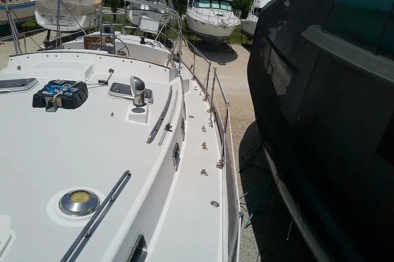 Slide: The Image of 1988 Brewer 44 yacht on dry dock, surrounded by other boats. - 20