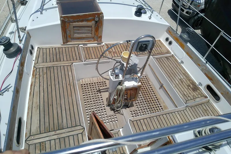 Slide: The Image of Cockpit of a 1988 Brewer 44 sailboat with wooden flooring and steering wheel. - 27
