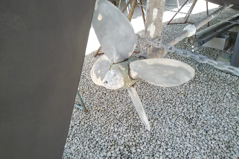 Slide: The Image of Propeller of a 1988 Brewer 44 sailboat on gravel surface. - 10