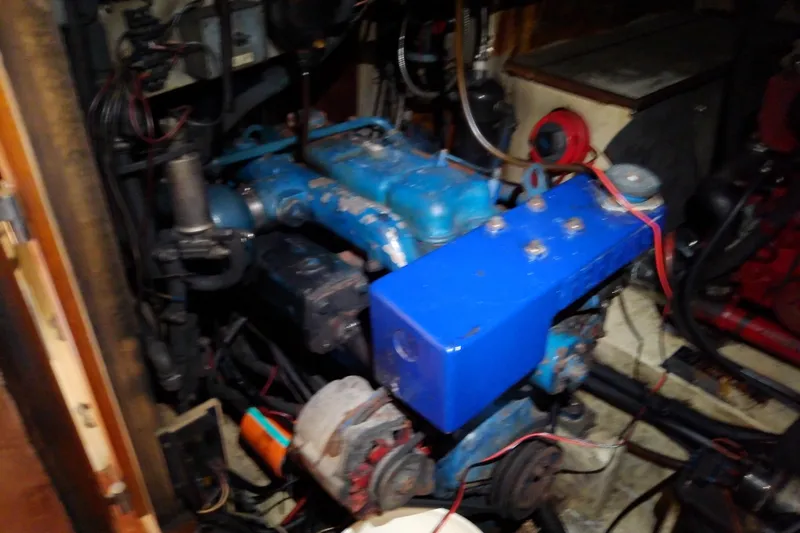 Slide: The Image of Engine compartment of a 1988 Brewer 44, showcasing mechanical components and wiring. - 74