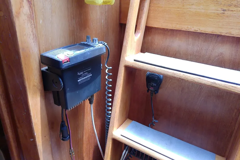 Slide: The Image of Vintage radio equipment in a 1988 Brewer 44 boat interior, mounted on wooden paneling. - 85