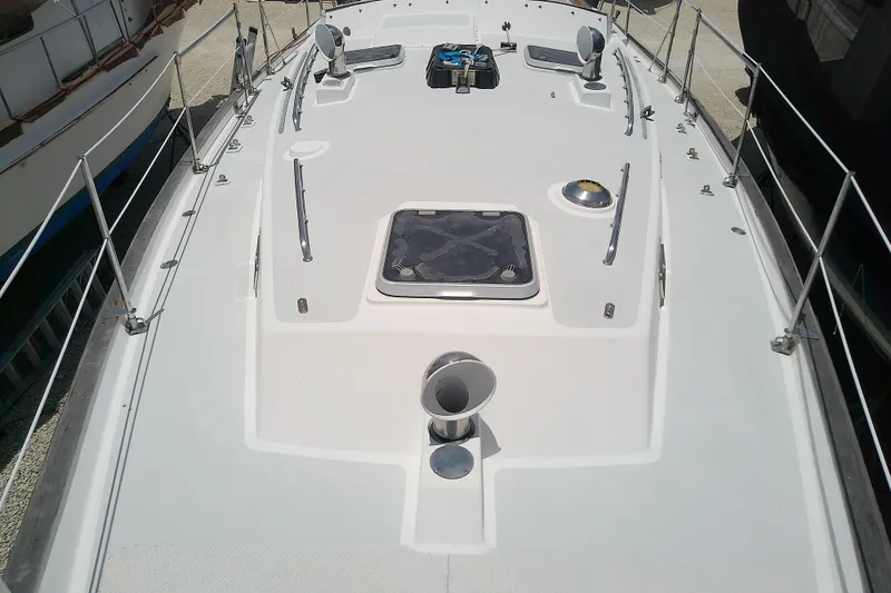 Slide: The Image of Deck view of a 1988 Brewer 44 sailboat, featuring hatches and railings. - 18