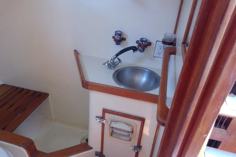 Slide: The Image of Compact bathroom in 1988 Brewer 44 yacht with sink and wooden accents. - 87