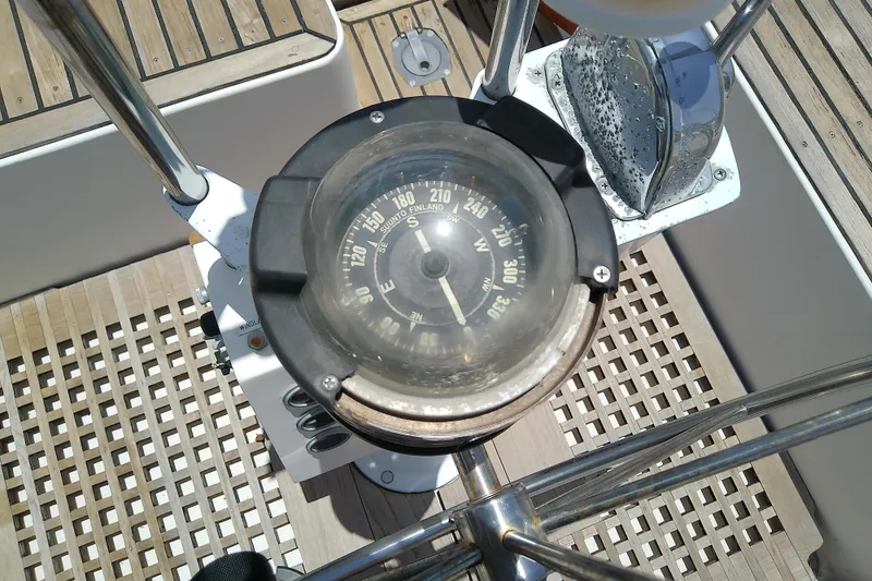 Slide: The Image of Compass on 1988 Brewer 44 yacht, surrounded by teak decking and stainless steel fittings. - 35