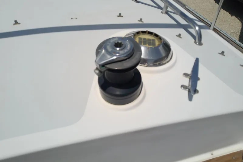 Slide: The Image of Deck of 1988 Brewer 44 sailboat featuring winch and cleat. - 32