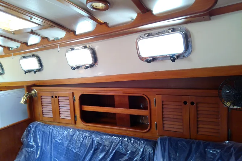 Slide: The Image of Interior of 1988 Brewer 44 sailboat with wooden cabinets and portholes. - 71