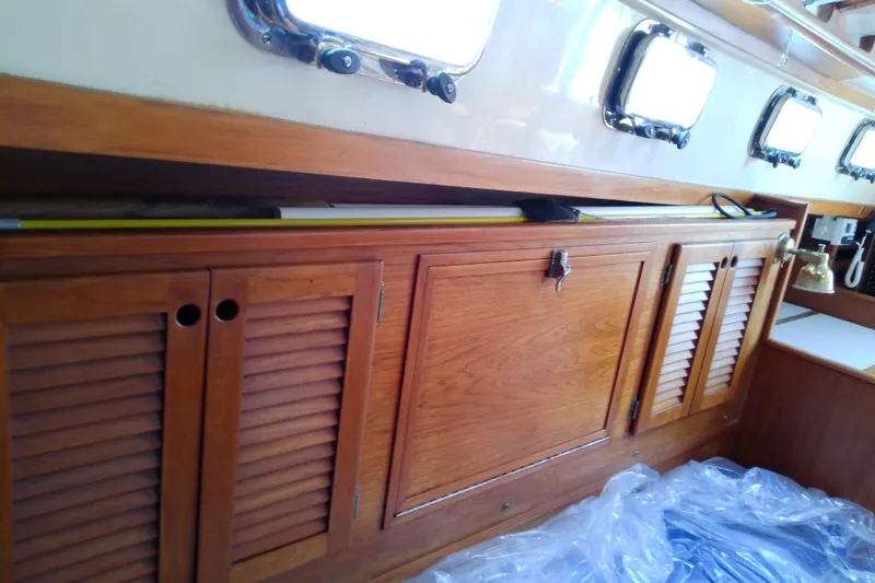 Slide: The Image of Interior of 1988 Brewer 44 yacht with wooden cabinets and portholes. - 72