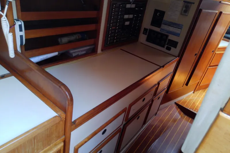 Slide: The Image of 1988 Brewer 44 yacht interior with wooden cabinetry and control panel. - 58