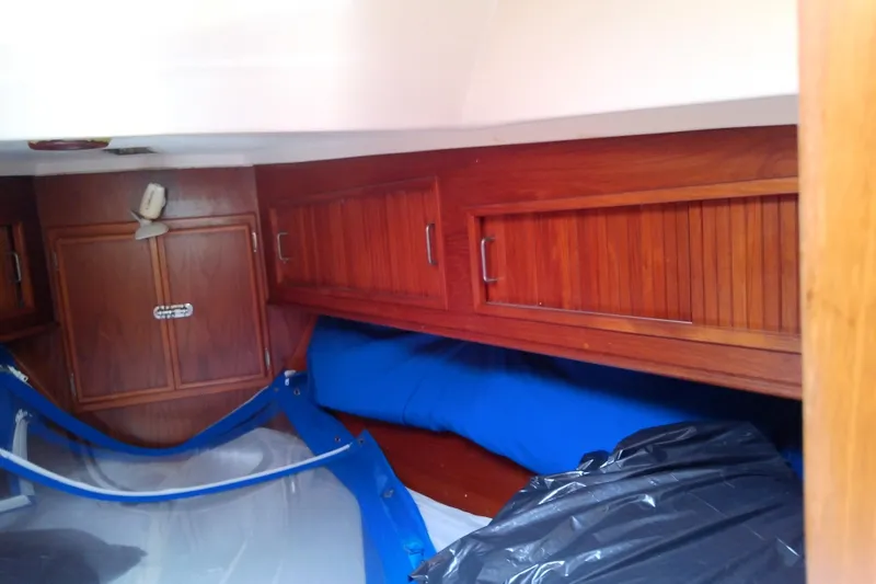 Slide: The Image of Interior cabin of a 1988 Brewer 44 sailboat with wooden storage cabinets. - 68